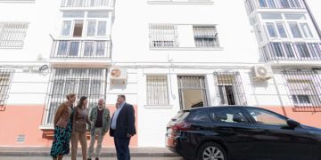 La comitiva de la alcaldesa posa junto a uno de los bloques ya adecentados / FOTO: Ayto.